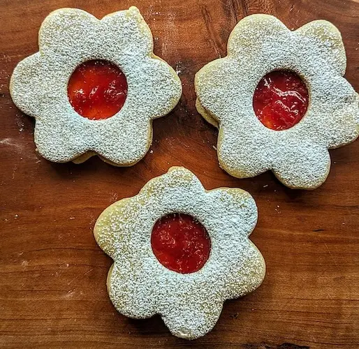 Strawberry Lemon Linzer soft cookie sandwiches filled with an in-house made strawberry vanilla lemon jam, topped with lemon zest and a dash of nutmeg.